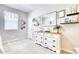 Well-lit bedroom with white dresser, mirror, and decorative shelving at 22235 E Cherrywood Dr, Queen Creek, AZ 85142