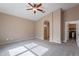 Neutral bedroom features carpeted floors, ceiling fan, and an arched doorway at 22235 E Cherrywood Dr, Queen Creek, AZ 85142