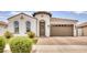 Spanish-style home with a two-car garage and landscaped front yard at 22235 E Cherrywood Dr, Queen Creek, AZ 85142