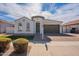 Charming single-story home with well-manicured landscaping and a two-car garage at 22235 E Cherrywood Dr, Queen Creek, AZ 85142