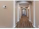 Elegant hallway featuring wood-like tile floors, leading to various rooms at 22235 E Cherrywood Dr, Queen Creek, AZ 85142