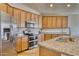 Modern kitchen with stainless steel appliances and granite countertops at 22235 E Cherrywood Dr, Queen Creek, AZ 85142