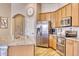 Kitchen with stainless steel appliances and wood cabinets at 22235 E Cherrywood Dr, Queen Creek, AZ 85142