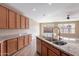 Well-lit kitchen with stainless steel appliances, granite countertops, and wood cabinets at 22235 E Cherrywood Dr, Queen Creek, AZ 85142