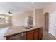 Kitchen island featuring granite countertops, a stainless steel sink, and wooden cabinets at 22235 E Cherrywood Dr, Queen Creek, AZ 85142