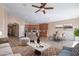 Open-concept living room with hardwood floors, modern furnishings, and a ceiling fan at 22235 E Cherrywood Dr, Queen Creek, AZ 85142