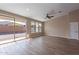 Bright living room features sliding glass doors, wood-look tile flooring, and recessed lighting at 22235 E Cherrywood Dr, Queen Creek, AZ 85142