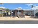 Tan mobile home with carport and landscaping at 2233 E Behrend Dr # 61, Phoenix, AZ 85024