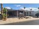 Tan mobile home with carport and landscaping at 2233 E Behrend Dr # 61, Phoenix, AZ 85024