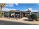 Tan mobile home with carport and landscaping at 2233 E Behrend Dr # 61, Phoenix, AZ 85024