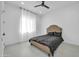 Bedroom with a tan headboard bed and dark bedding, featuring a ceiling fan at 22707 W La Mirada Dr, Buckeye, AZ 85326