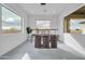 Bright dining room featuring a glass table and modern chairs at 22707 W La Mirada Dr, Buckeye, AZ 85326