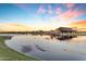 Scenic community lake with sunset views and a clubhouse at 22812 E Excelsior Ave, Queen Creek, AZ 85142