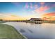 Scenic community lake with sunset views and a clubhouse at 22812 E Excelsior Ave, Queen Creek, AZ 85142