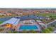 Aerial view of community pool with cabanas, lake, and a playground in a well-planned residential neighborhood at 22812 E Excelsior Ave, Queen Creek, AZ 85142