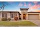 House exterior with a two-car garage and stone accents at 22812 E Excelsior Ave, Queen Creek, AZ 85142