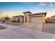 Two-car garage and front yard landscaping with stone accents at 22812 E Excelsior Ave, Queen Creek, AZ 85142