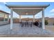 Covered patio with outdoor kitchen and dining area at 22812 E Excelsior Ave, Queen Creek, AZ 85142