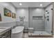 Bathroom features a soaking tub, walk in shower, and modern gray tile at 2302 N Central Ave # 401, Phoenix, AZ 85004