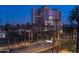 Night view of condo building, city street, and palm trees at 2302 N Central Ave # 401, Phoenix, AZ 85004