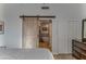 Main bedroom with barn door leading to en-suite bathroom with a free-standing tub at 2302 N Central Ave # 401, Phoenix, AZ 85004