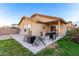 Covered patio with seating area, grill, and desert landscaping at 24246 W Tonto St, Buckeye, AZ 85326