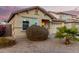 House exterior showcasing a two-car garage and drought-tolerant landscaping at 24246 W Tonto St, Buckeye, AZ 85326