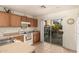 Kitchen features wood cabinets, white appliances, and sliding door to patio at 24246 W Tonto St, Buckeye, AZ 85326