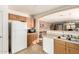 Well-equipped kitchen with white appliances and wood cabinets at 24246 W Tonto St, Buckeye, AZ 85326