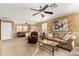 Living area featuring a built-in entertainment center and ceiling fan at 24246 W Tonto St, Buckeye, AZ 85326