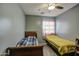 Bedroom with two twin beds and ceiling fan at 2524 W Saint Catherine Ave, Phoenix, AZ 85041