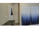 Small bedroom with a desk and blue curtains at 2524 W Saint Catherine Ave, Phoenix, AZ 85041