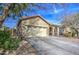 Tan house with arched entryway, two-car garage, and desert landscaping at 2524 W Saint Catherine Ave, Phoenix, AZ 85041