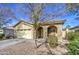 Tan house with arched entryway, two-car garage, and desert landscaping at 2524 W Saint Catherine Ave, Phoenix, AZ 85041