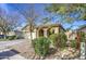 Tan house with arched entryway, two-car garage, and desert landscaping at 2524 W Saint Catherine Ave, Phoenix, AZ 85041