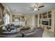 Open living room with leather furniture and entertainment center at 2524 W Saint Catherine Ave, Phoenix, AZ 85041