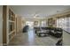 Spacious living room with tile flooring, built-in shelving, and a large sectional sofa at 2524 W Saint Catherine Ave, Phoenix, AZ 85041