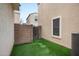 Low maintenance backyard features artificial grass, and a block wall for privacy at 2646 E Megan St, Gilbert, AZ 85295