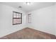 Bright bedroom features neutral carpet, two windows with blinds, and clean white walls at 2646 E Megan St, Gilbert, AZ 85295