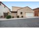 Exterior view of a home with a two car garage and desert landscaping at 2646 E Megan St, Gilbert, AZ 85295