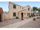 Charming two-story stucco home featuring a red door, tidy landscaping, and a paved walkway at 2646 E Megan St, Gilbert, AZ 85295