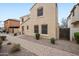 Side view of stucco house featuring tidy landscaping, walkway, window screens, and a side gate at 2646 E Megan St, Gilbert, AZ 85295