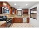 Traditional kitchen featuring stainless steel appliances, wooden cabinets, and granite countertops at 2646 E Megan St, Gilbert, AZ 85295