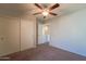 Bedroom with ceiling fan, carpet, and sliding door closet at 2960 E Darrow St, Phoenix, AZ 85042