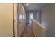 Upper level hallway with carpeted flooring and doors to bedrooms at 2960 E Darrow St, Phoenix, AZ 85042