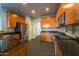 Modern kitchen featuring dark granite countertops and wood cabinetry at 2960 E Darrow St, Phoenix, AZ 85042