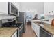 Modern kitchen with stainless steel appliances, granite countertops, and a view of the dining area at 2992 N Miller Rd # 210A, Scottsdale, AZ 85251