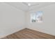 Well-lit bedroom featuring wood-look floors and a window with blinds at 2992 N Miller Rd # 210A, Scottsdale, AZ 85251