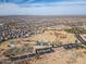 An aerial view of the community with a focus on the community park featuring sports fields and playground at 30968 W Monterey Ave, Buckeye, AZ 85396