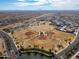 Aerial view of the community park offering baseball fields, green spaces, and recreational facilities, set against a mountain backdrop at 30968 W Monterey Ave, Buckeye, AZ 85396